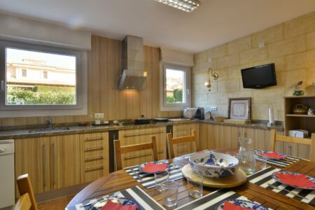 Kitchen And Dining Area In Three Bedroom Apartment With A Terrace In Palmanova